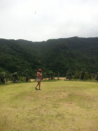 Full length of man on golf course against sky