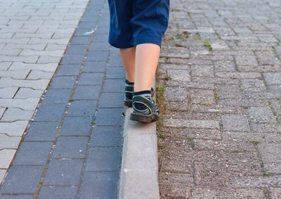 Low section of woman on footpath