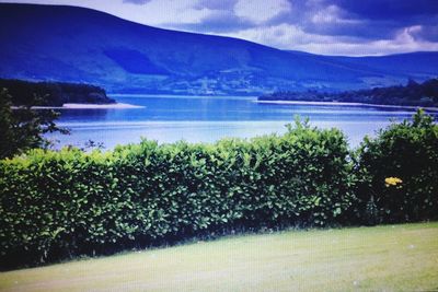 Scenic view of lake and mountains against sky