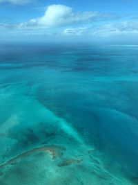 Aerial view of sea against blue sky