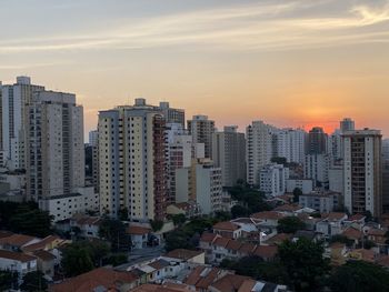 High angle view of buildings in city against sky during sunset