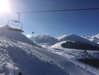 Scenic view of ski lift against sky