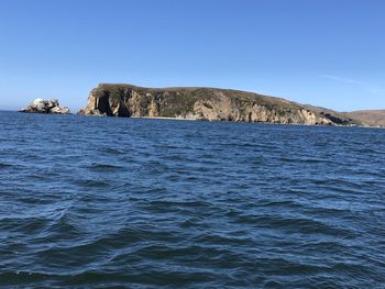 Scenic view of sea against clear blue sky