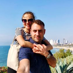 Portrait of couple against sky