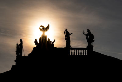 Silhouette people against sky during sunset