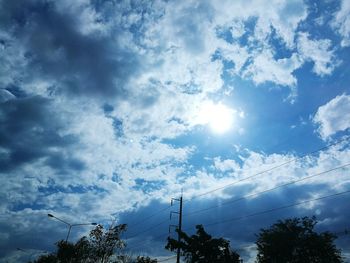 Low angle view of silhouette trees against sky