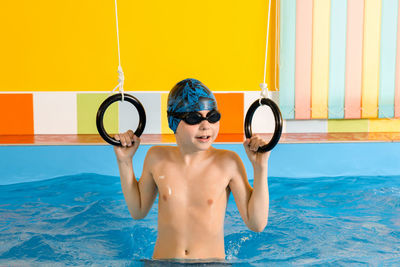 Shirtless boy in swimming pool