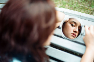 Portrait of cute girl with reflection on window