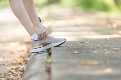 Low section of woman walking outdoors