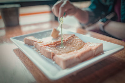 Close-up of person having food in restaurant