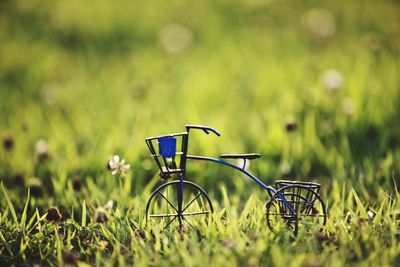 Close-up of toy bicycle on grassy field