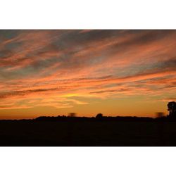 Scenic view of landscape against sky at sunset