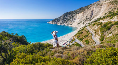 Man standing by sea against sky