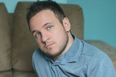 Portrait of young man at home