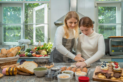 Woman preparing food on table at home