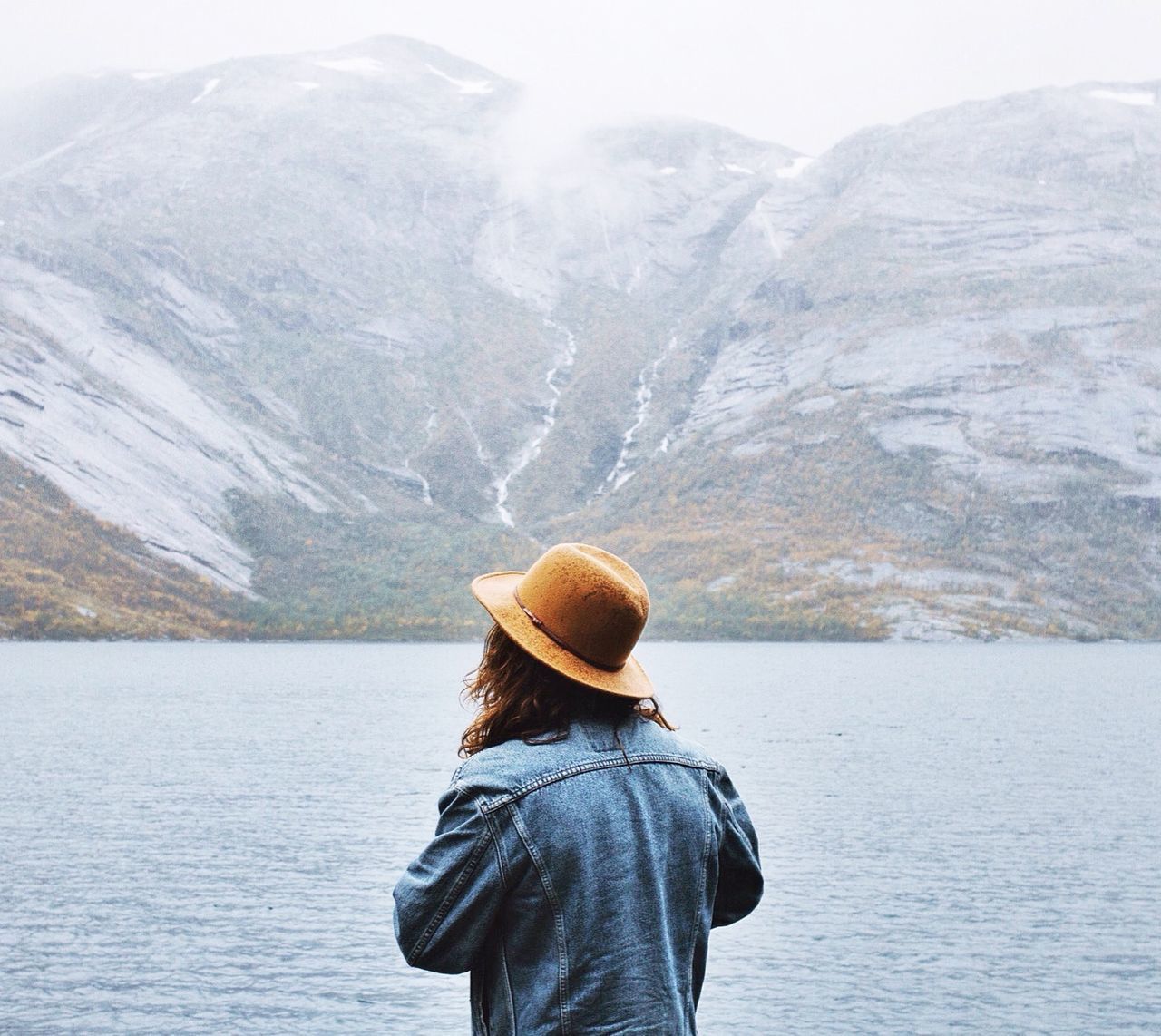 mountain, cold temperature, winter, snow, rear view, lifestyles, mountain range, leisure activity, tranquil scene, men, standing, tranquility, scenics, beauty in nature, season, nature, looking at view, lake