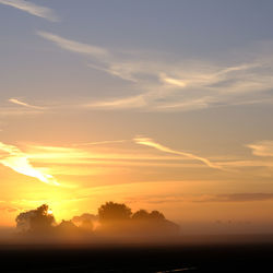 Scenic view of silhouette trees against sky during sunset