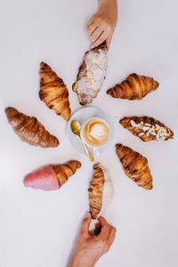 Directly above shot of person preparing food against white background