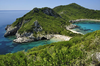 High angle view of sea and mountains against clear sky