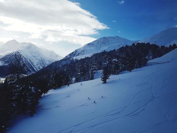 Scenic view of snow covered mountains against sky