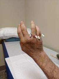 Close-up of person hand on bed