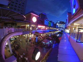 People in illuminated city at night