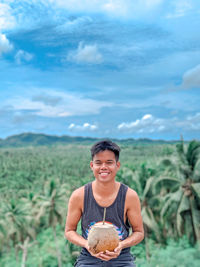 Portrait of a smiling young man in field