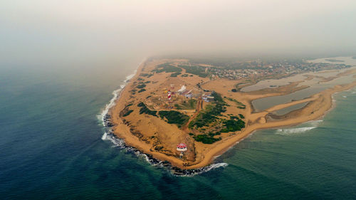 High angle view of ship on sea shore against sky