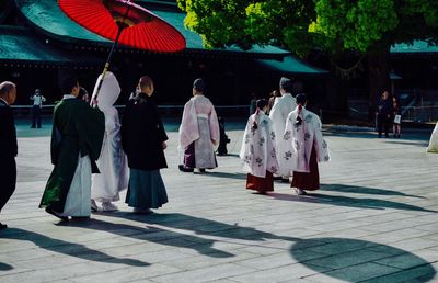 Rear view of people walking in temple