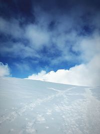 Snow covered landscape against sky