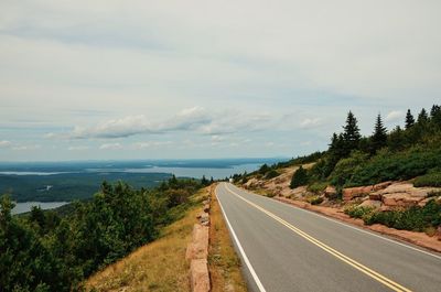 View of empty road leading to sea