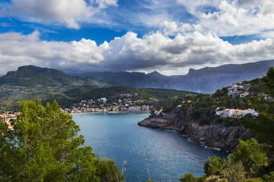 High angle view of townscape by sea against sky