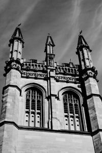 Low angle view of cross on building against sky