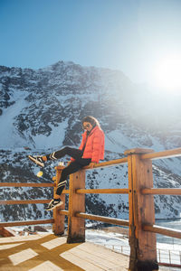 Sun rays light up a female tourists smile in the mountains