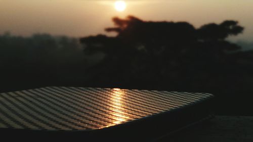 Close-up of water against sky at sunset