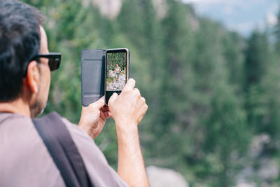 Rear view of man photographing