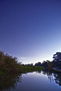 Scenic view of lake against star field at night