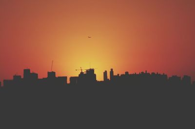 Buildings in city at sunset