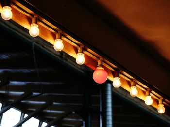 Low angle view of illuminated lights at night