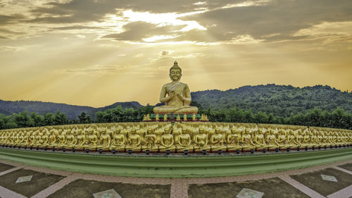 Statue of temple against cloudy sky