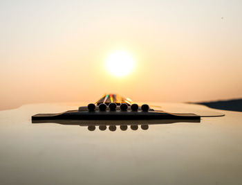 Reflection of color on guitar strings during sunset