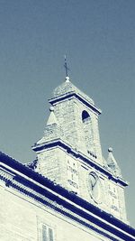 Low angle view of bell tower against sky