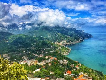 High angle view of sea and mountains against sky