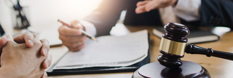 Close-up of man holding hands on table