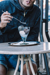 Young man sitting on table