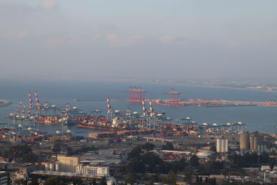 High angle view of buildings by sea against sky