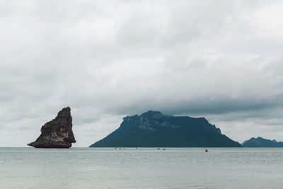 Scenic view of sea and mountains against sky