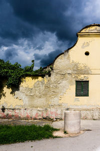 Buildings against cloudy sky