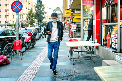 Full length of man on street in city