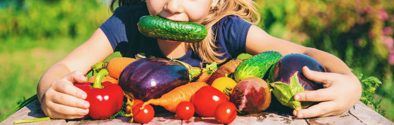 Cropped hand of woman holding vegetables